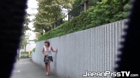 Shameless young Japanese girl urinates on the sidewalk