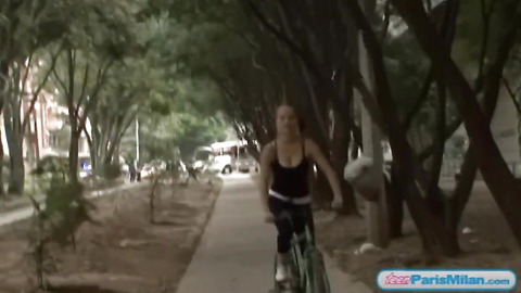 Busty solo teen riding her bike through the park