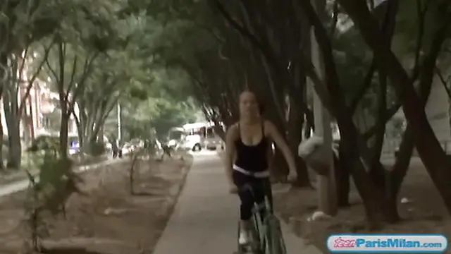 Busty teen rides alone through the park on her bike