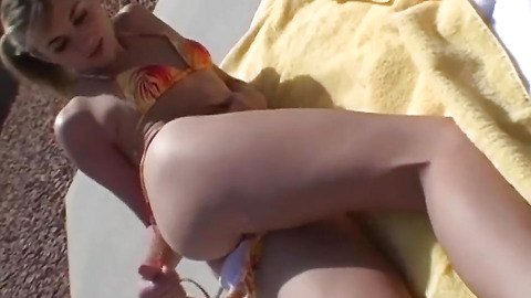 Hot blonde model shows off her body in a bikini in public